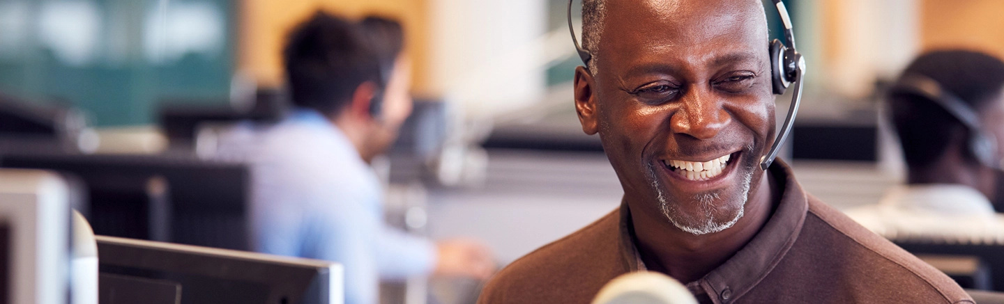 Call center agents wearing headsets at work.