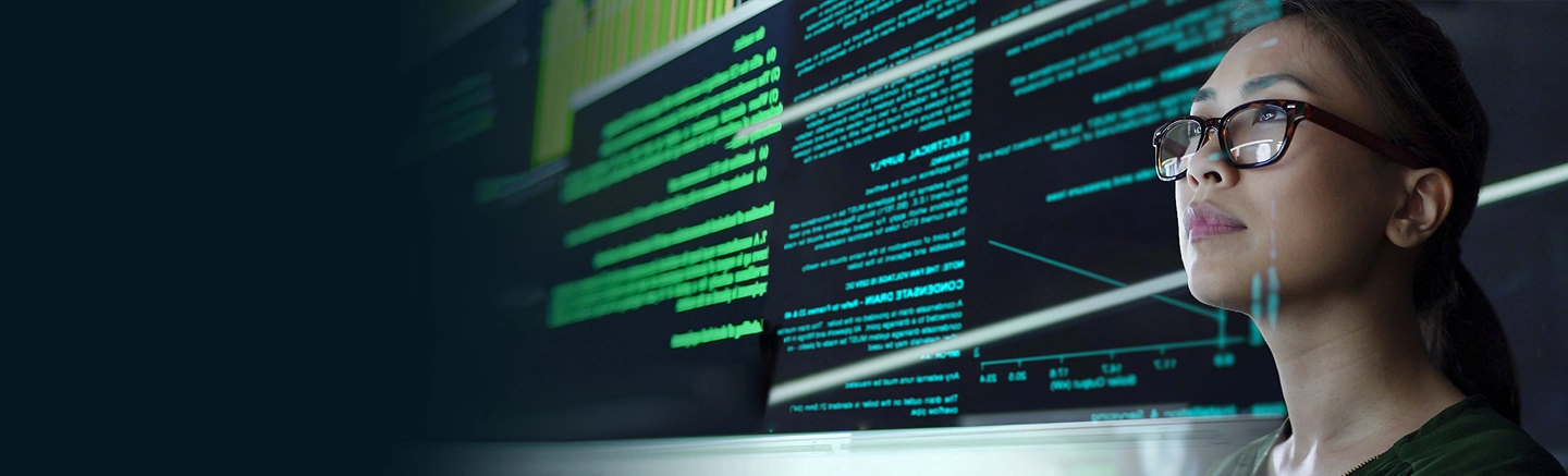 Woman in IT looking at data on a screen.