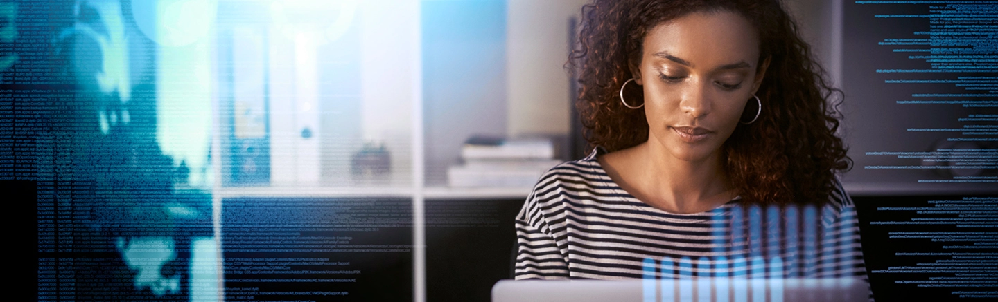 Person coding on laptop in tech-focused workspace.