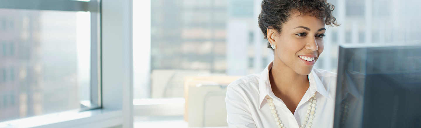 Lady smiling working on a computer
